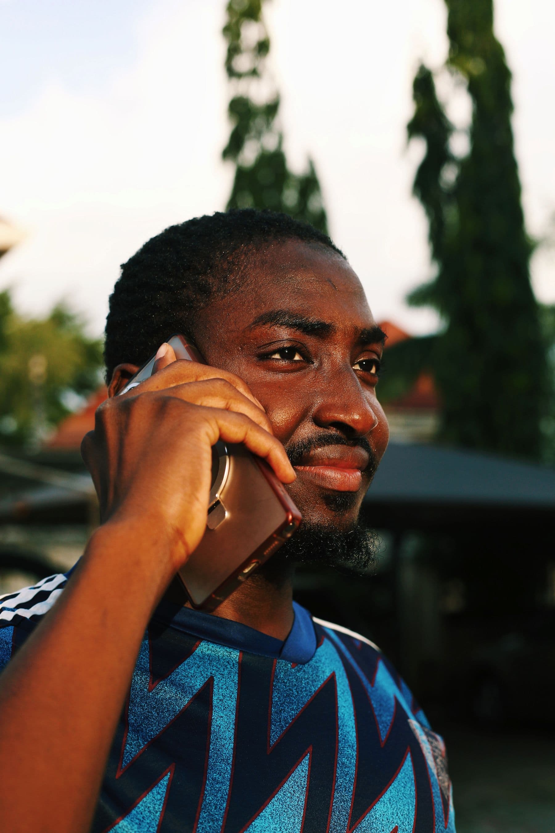 A woman on a video call with a man and a child on her phone screen